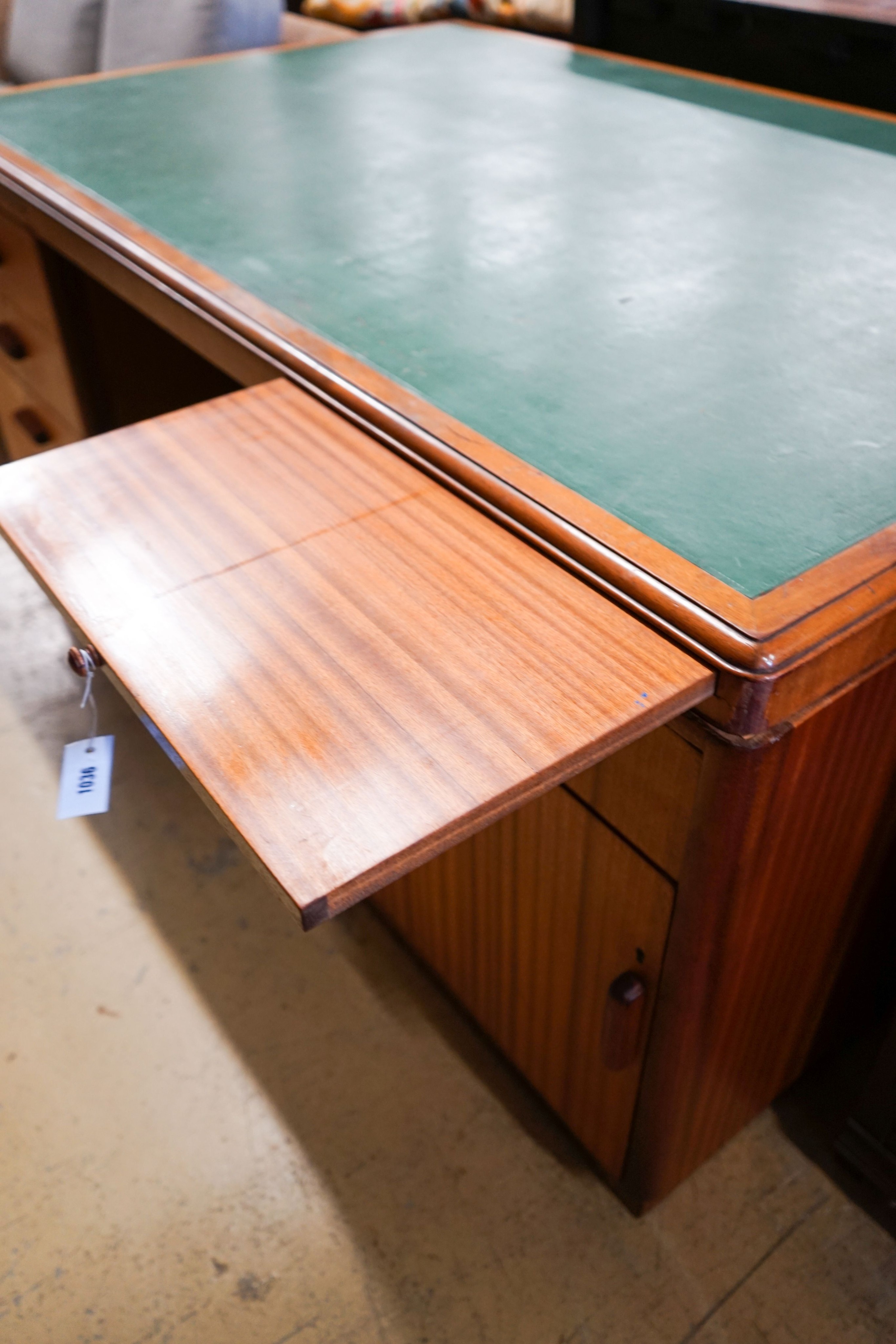 A mid century design teak kneehole desk, bears a Waring & Gillow stamp, length 168cm, depth 106cm, height 74cm